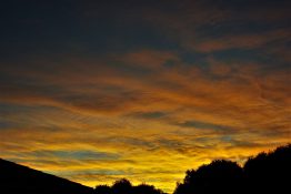 Colourful start to the day with beautiful streak of colours from the rising highlighting the clouds and the sky