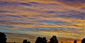 Colourful start to the day with beautiful streak of colours from the rising highlighting the clouds and the sky