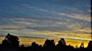 Colourful start to the day with beautiful streak of colours from the rising highlighting the clouds and the sky