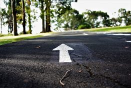 Arrow markings painted on the road to indicate the direction of traffic