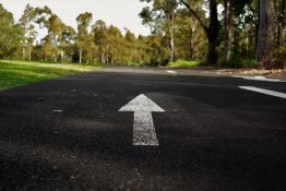 Arrow markings painted on the road to indicate the direction of traffic