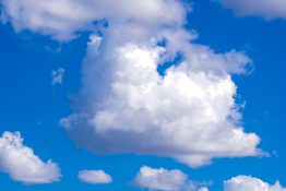 Beautiful white cotton wool like clouds on a bright day