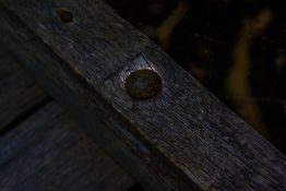 Rusted bolt screwed into an piece of timber