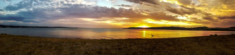 Beautiful sunset at Lake Taupou in New Zealand.