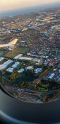 Looking at buildings and homes from a planes window as it circles over a residential area