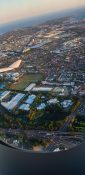 Looking at buildings and homes from a planes window as it circles over a residential area