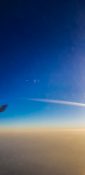 Beautiful evening view from a planes window as it cruises over the clouds