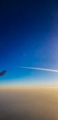 Beautiful evening view from a planes window as it cruises over the clouds