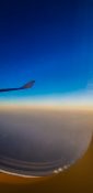 Beautiful evening view from a planes window as it cruises over the clouds