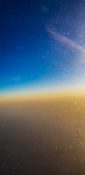 Beautiful evening view from a planes window as it cruises over the clouds