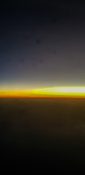 Beautiful evening view from a planes window as it cruises over the clouds