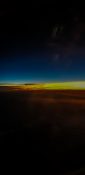 Beautiful evening view from a planes window as it cruises over the clouds