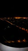 Night view of Auckland as plane descends to land at the airport