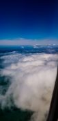 Beautiful view of ocean and clouds from a planes window