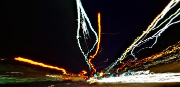 Uneven trail of lights created when taking long exposure shot from a moving vehicle