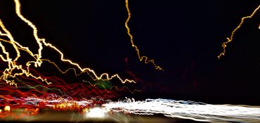 Uneven trail of lights created when taking long exposure shot from a moving vehicle