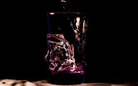 Different light and colours used to add colorful effects to glass of water