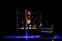 Tea light candle lit in a candle holder creating beautiful shapes and shadows