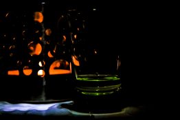 Tea light candle lit in a candle holder creating beautiful shapes and shadows