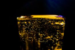 Bubbles formed in a glass after pouring fizzy drink in it