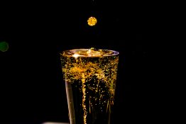 Bubbles formed in a glass after pouring fizzy drink in it