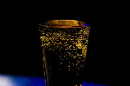 Bubbles formed in a glass after pouring fizzy drink in it