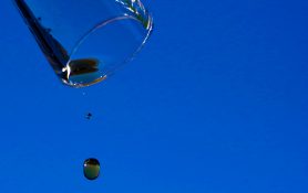 Carbonated drinks drops out of a tilted glass