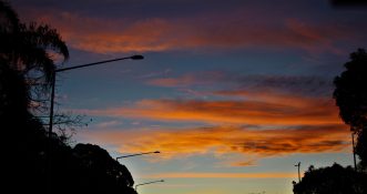 Crane at a construction site late in the afternoon with the back drop of evening colorful clouds